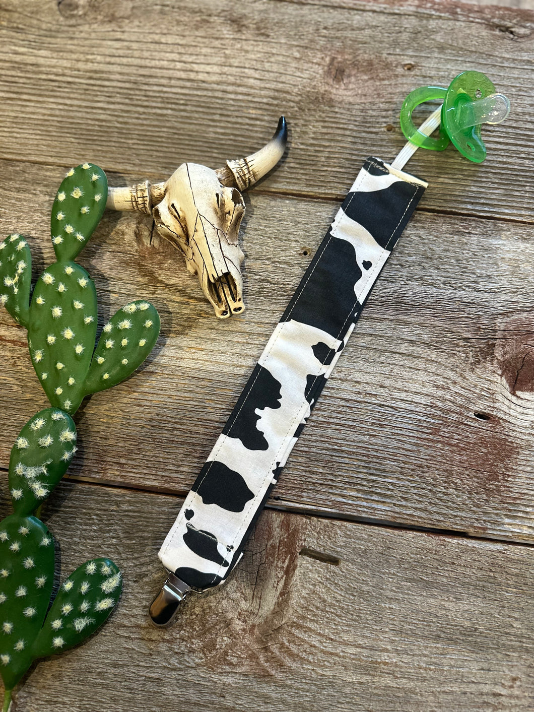 Black and white cowprint pacifier clip