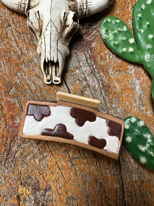 Brown and white tooled claw clip
