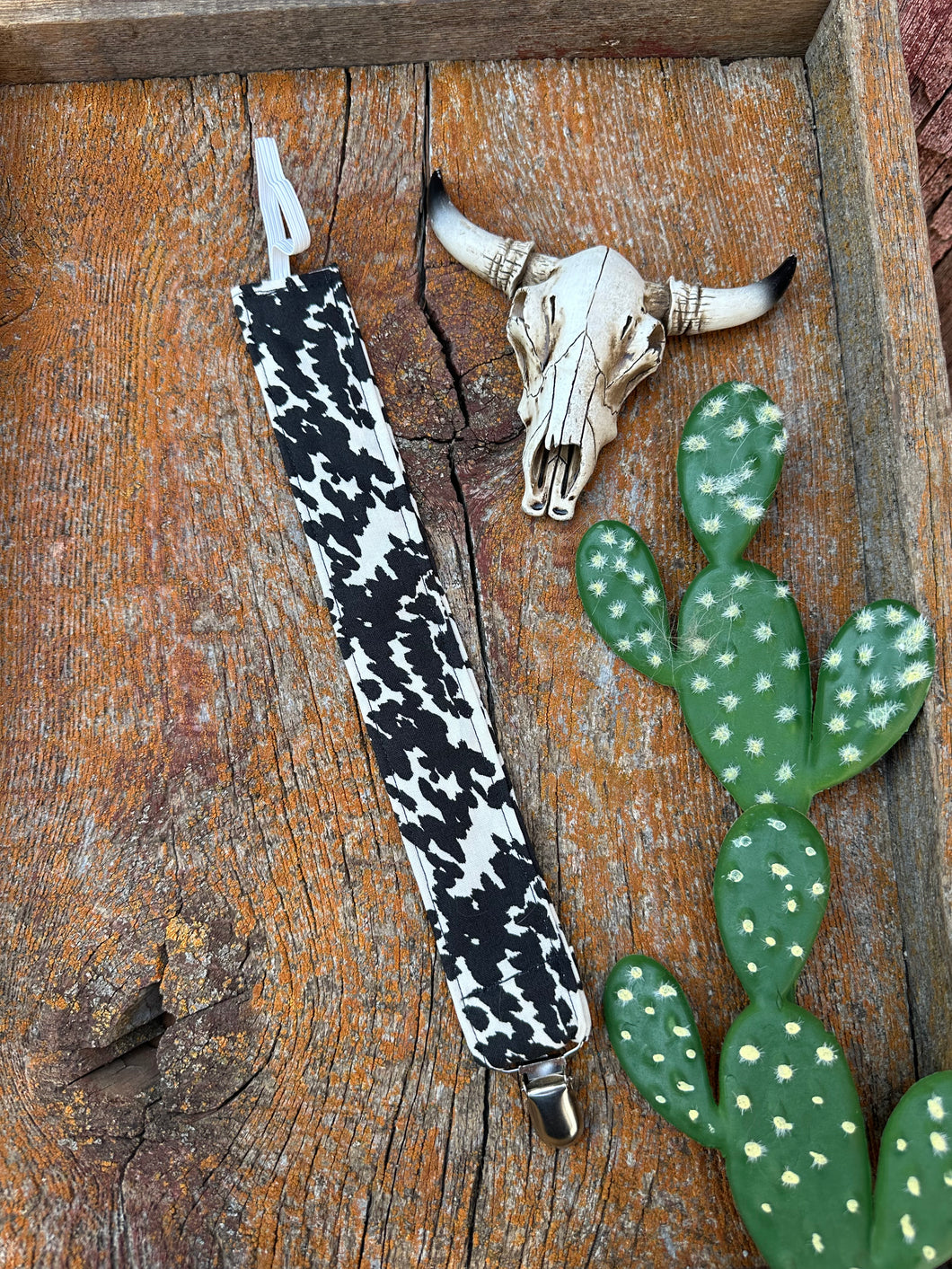 Black and white cowprint baby pacifier clip