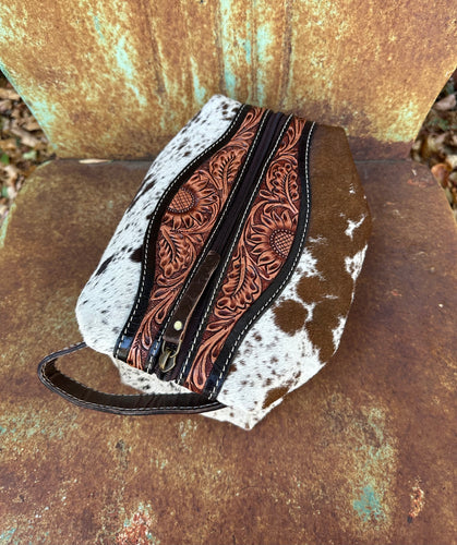 Brown and white tooled cowhide makeup bag