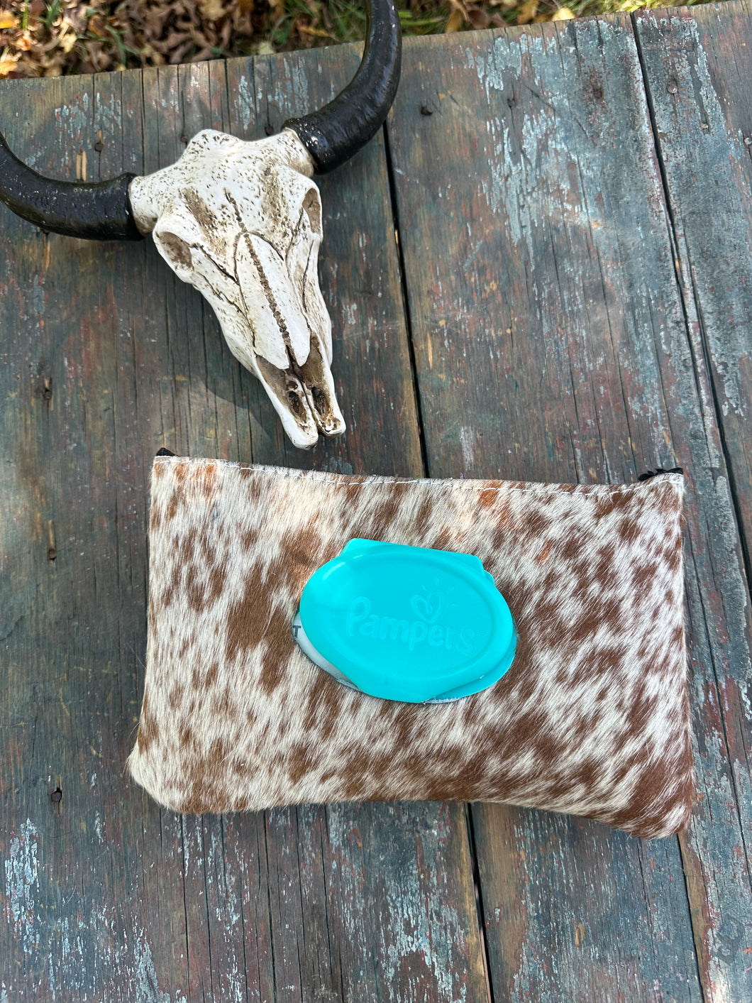 Brown and white speckled hair on hide baby wipes case