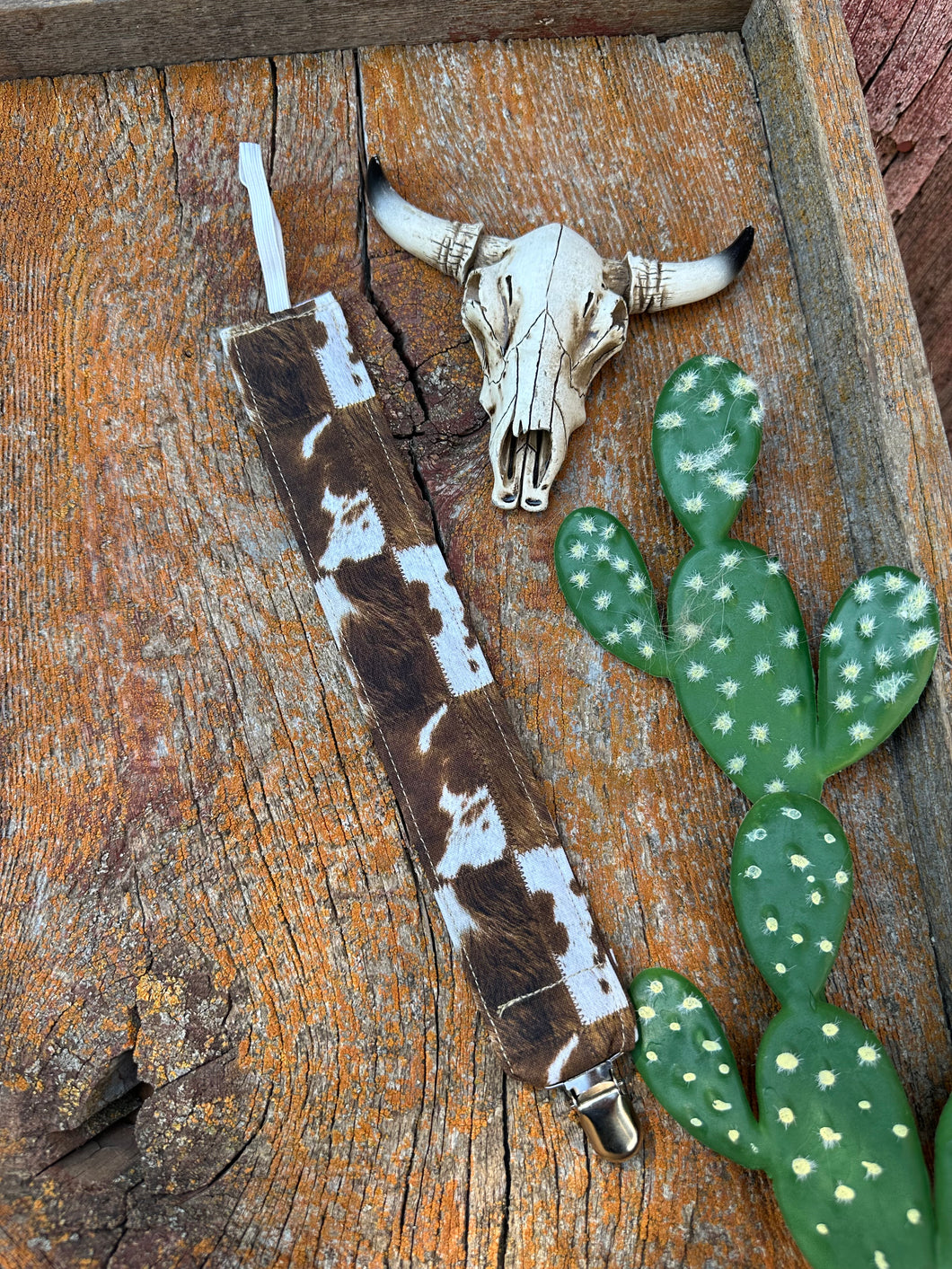 Brown and white cowprint pacifier clip